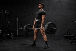 Powerlifter performing a heavy conventional deadlift in a gym while focusing on bar path, full-body strength, lifting technique, and efficient movement mechanics to improve powerlifting performance and maximize strength development.